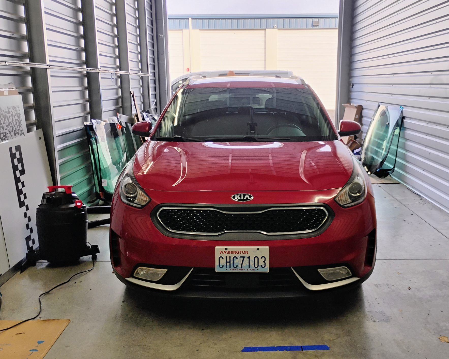 Red car parked in a storage unit.