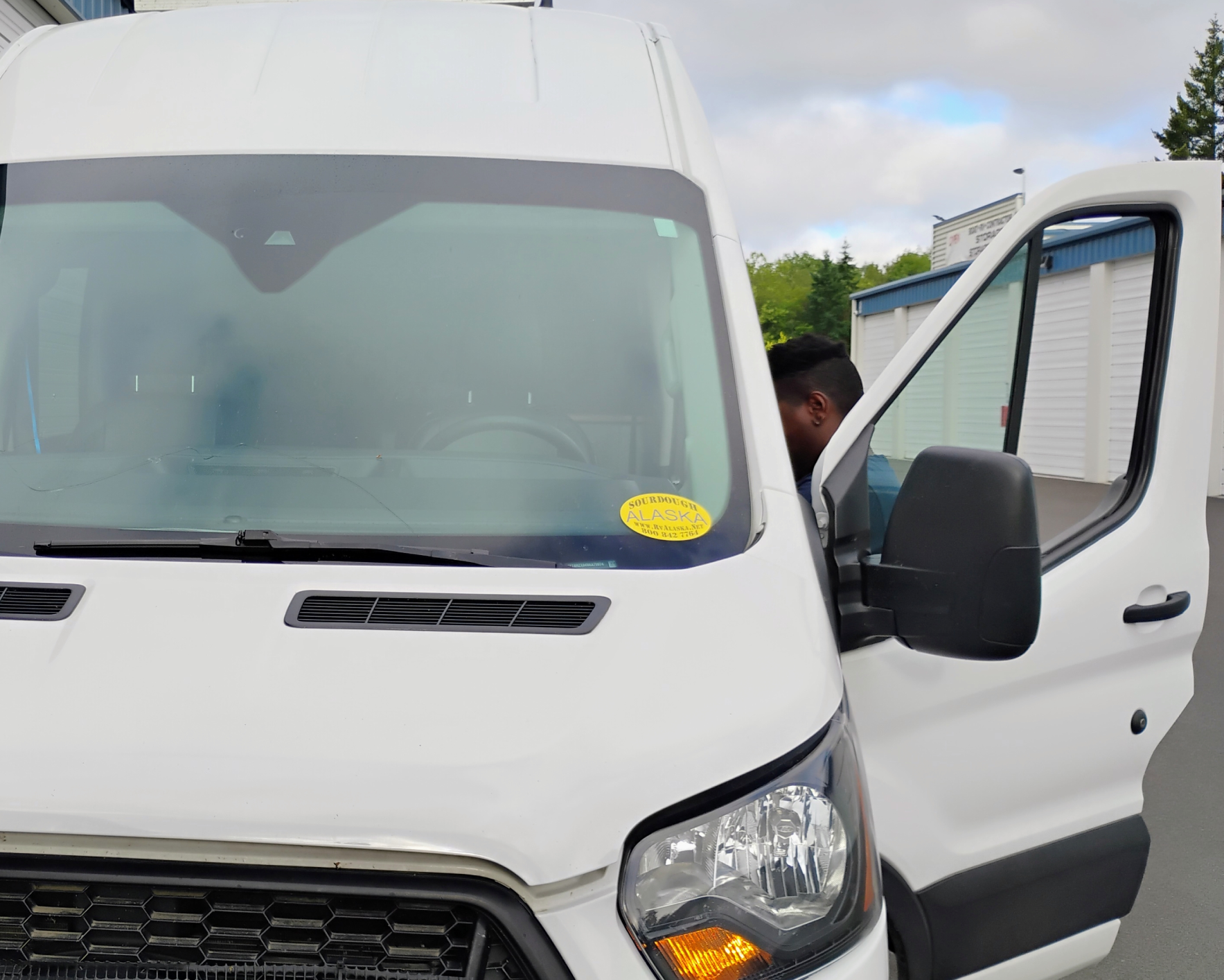 White van with open driver's door.