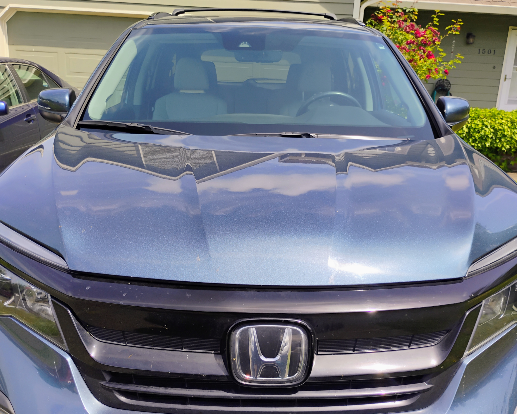 Blue Honda SUV parked in driveway.